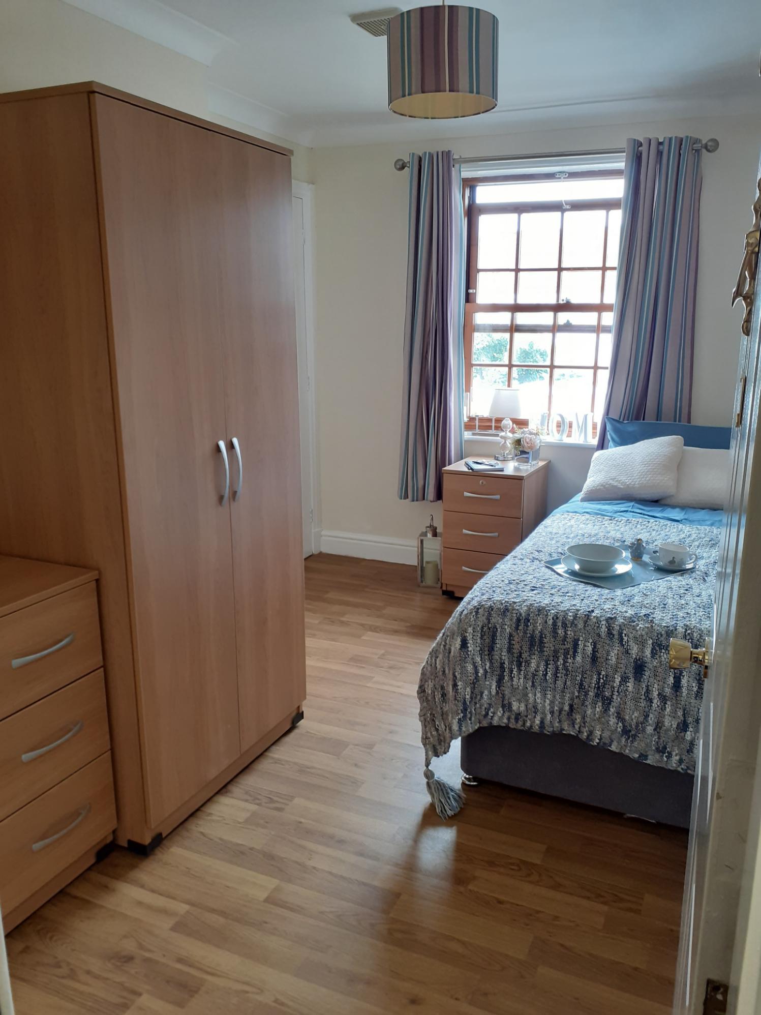 bedroom with wooden furniture and wooden flooring